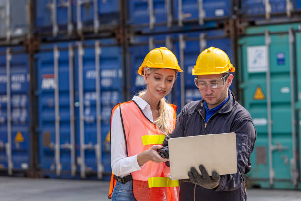 engineer people work in port cargo container shipping yard using laptop operate with customs2163784183
