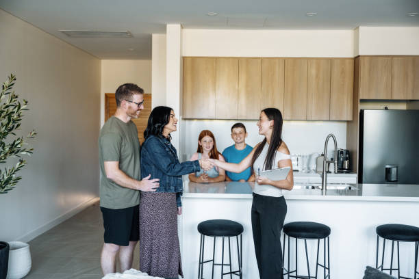 family with two young kids insuring new house and talking to professional agent insurance2187986227