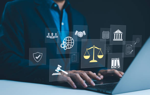 legal professional with justice icons legal professional using laptop with virtual icons2168600965